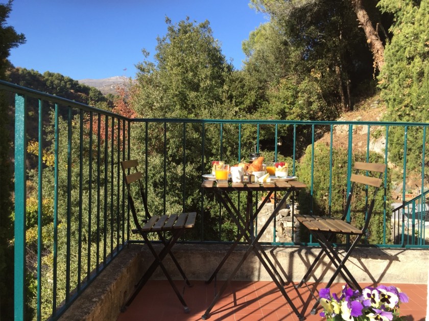 A table laid for breakfast on the terrace at Villa Rocamar