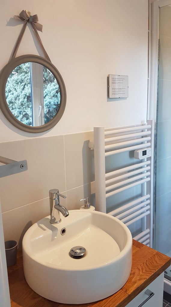 Sink, mirror and towel rail in bathroom of St Jeannet bedroom